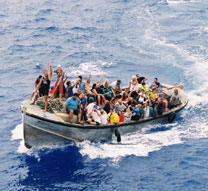 The entire population of Pitcairn Island waves to the M.V. Discovery from their longboat.